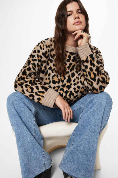 Leopard-print knit sweater with ribbed cuffs and crew neck, model seated