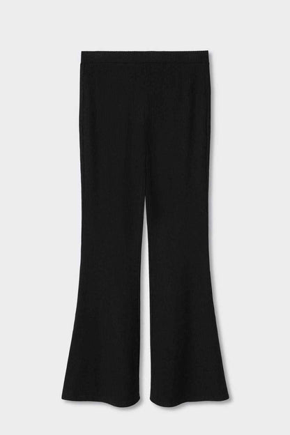 Black flared trousers on a flat lay, wide bell legs and straight hem