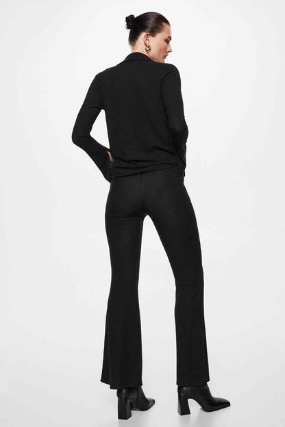 Black flared trousers, back view with fitted hip and wide bell leg opening