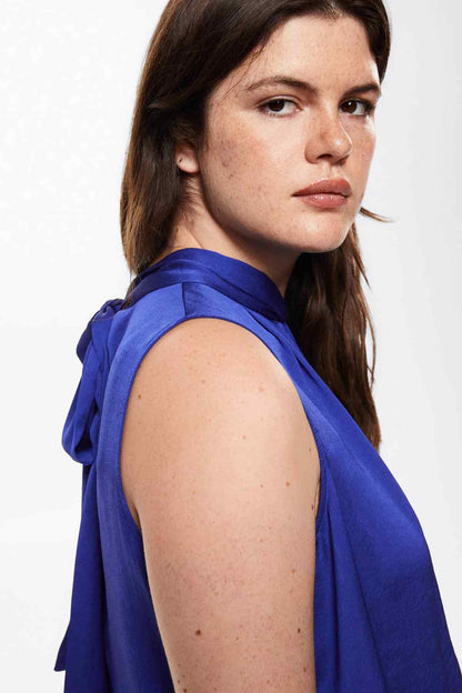 Blue sleeveless blouse with draped shoulder and neck tie