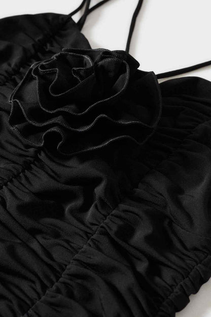 Mango black ruched camisole fabric close-up with layered rosette trim