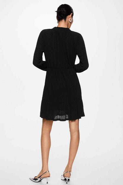 Black long-sleeve V-neck mini dress, back view with gathered waist and hem