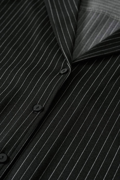 Black pinstripe blazer fabric close-up with black buttons