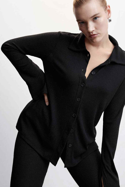 Black knit button-up jacket front view with pointed collar and long sleeves
