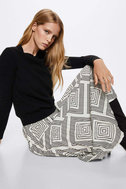 Pleated geometric midi skirt with bold black lines on a white base