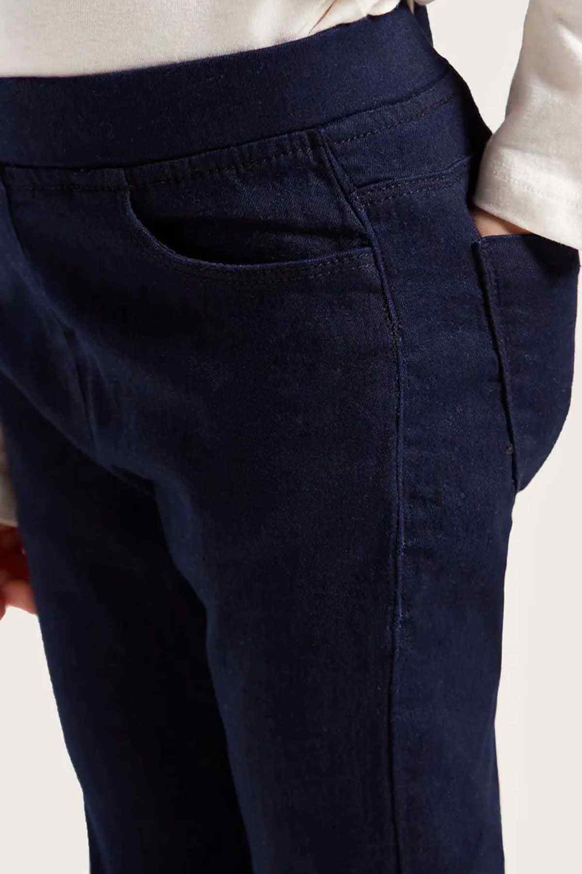 Close-up of dark navy kids' pants with front seam and button placket