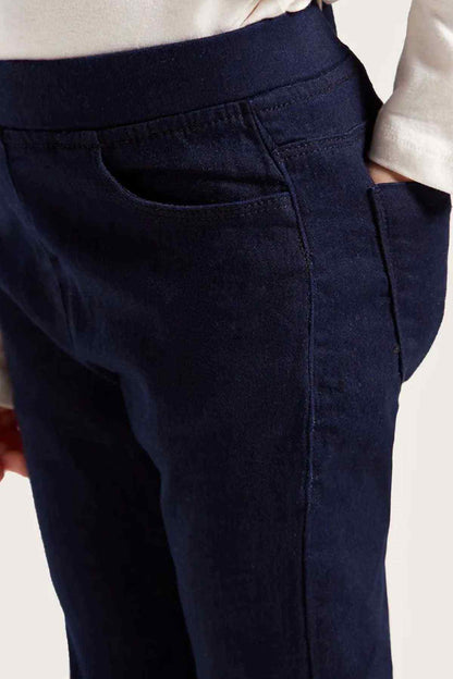 Close-up of dark navy kids' pants with front seam and button placket