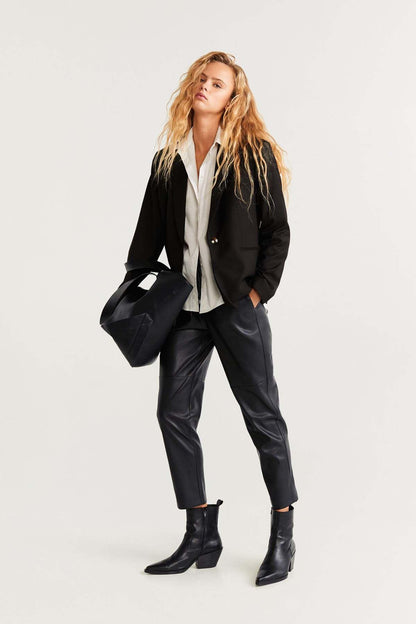 MANGO black blazer and trousers with white blouse, boots, and black tote bag