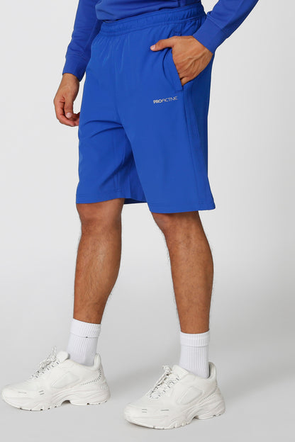 Blue athletic shorts with elastic waistband and logo on thigh, mid-thigh length