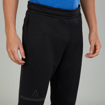 Black jogger pants close-up with knee panel and small logo mark