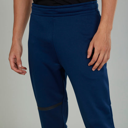 Men's blue jogger pants with elastic waistband and contrast patch on the thigh