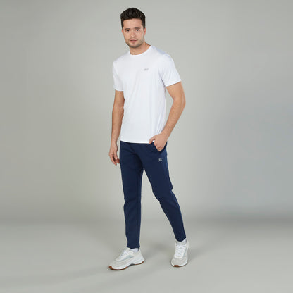 Men's white short-sleeve T-shirt with small chest logo, paired with navy pants