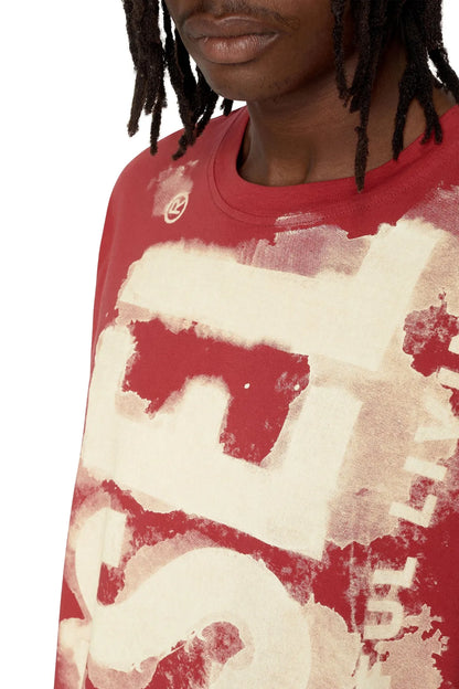 Red T-shirt front close-up with distressed white graphic print