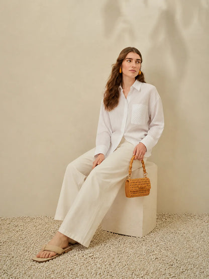 White button-up shirt and wide-leg trousers, long sleeves and front placket