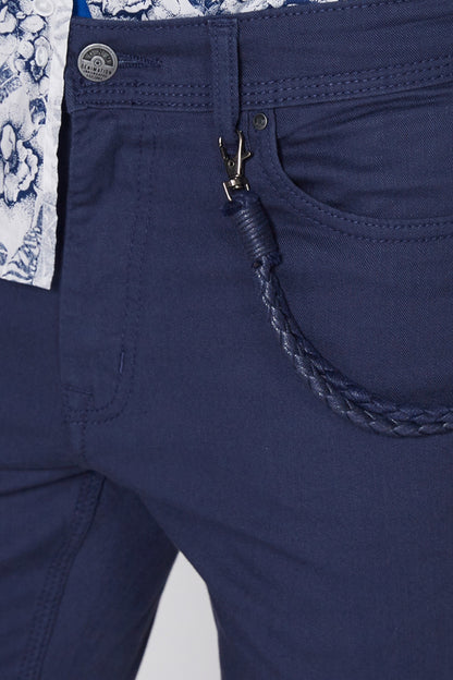Dark blue shorts close-up with metal button, zipper fly, and stitched pocket trim