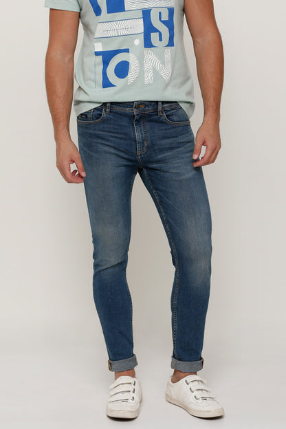 Men's blue denim jeans with belt loops, button fly, and contrast stitching