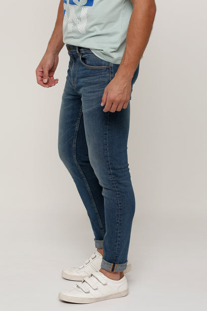 Blue slim-fit denim jeans with five pockets and visible side seams