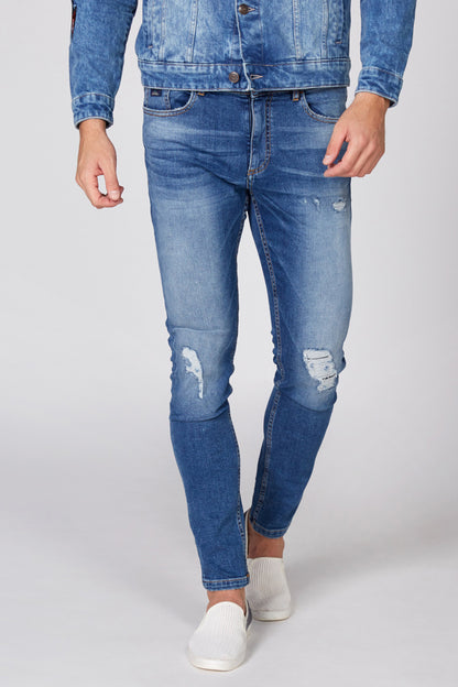Blue distressed slim jeans with knee and thigh rips and belt loops