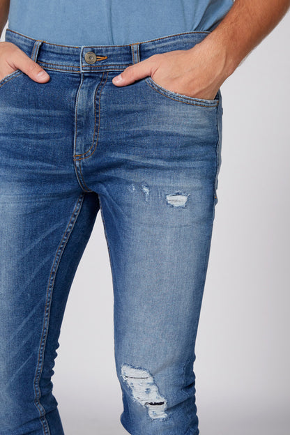 Blue slim-fit ripped jeans with button waistband and distressed knee patches
