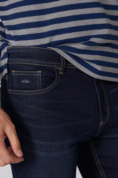 Close-up of blue striped polo top over dark jeans pocket