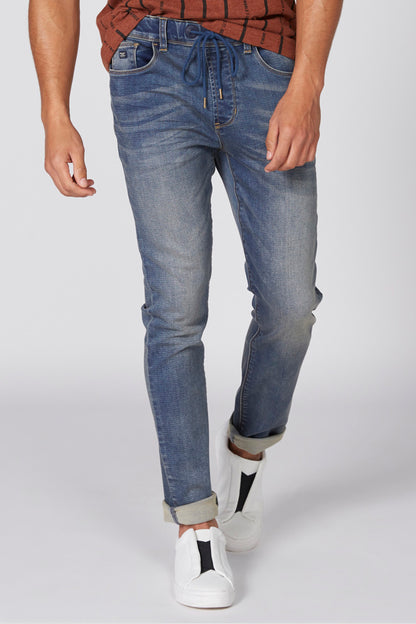 Light blue denim jeans with five pockets, belt loops, and rolled cuffs