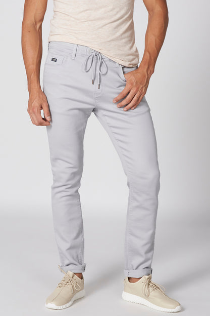 Light blue drawstring waist pants, tapered fit, stitched seams at thighs