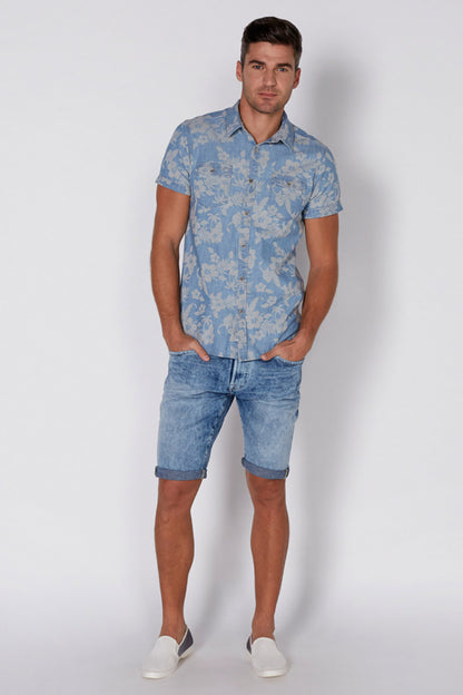 Men's blue floral short-sleeve shirt with collar, worn with denim shorts