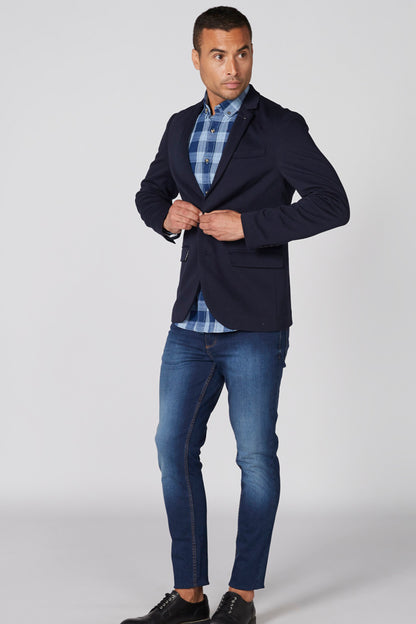Blue plaid button-up shirt with pointed collar, button front, worn under dark jacket