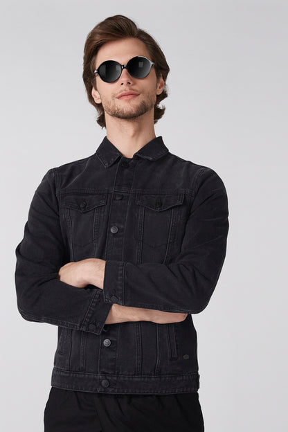 Black denim jacket with button front and flap chest pockets, long sleeves.