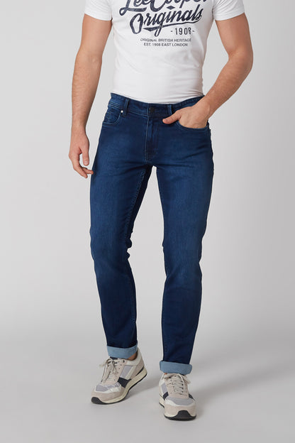 Blue denim jeans with five pockets, belt loops, and stitched seams