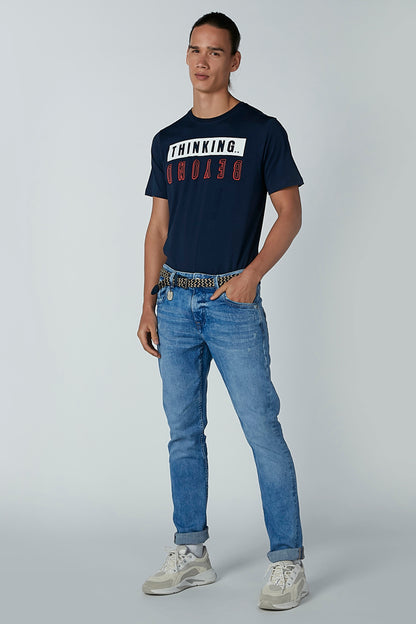 Blue denim jeans with woven belt, relaxed fit and rolled cuffs