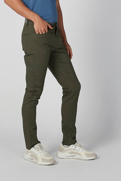 Men's olive green cargo pants close-up with belt loops, side pockets, and stitched seams