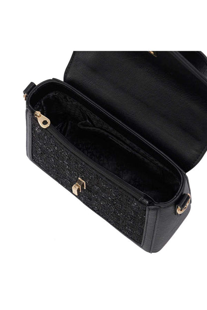Black mini handbag showing interior with side opening and crossbody strap