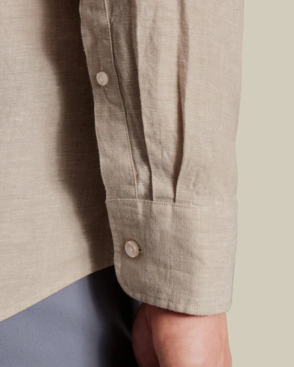 Light beige button-up shirt cuff with single button and stitched sleeve seam