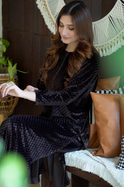 Black textured velour maxi dress with long sleeves and front zipper, draped front