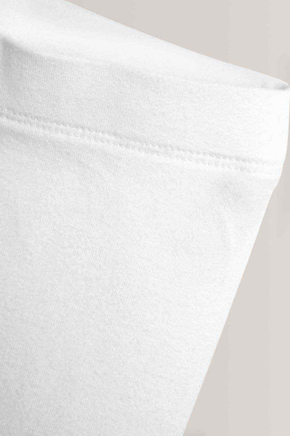 White fabric close-up of trouser hem and stitched edge