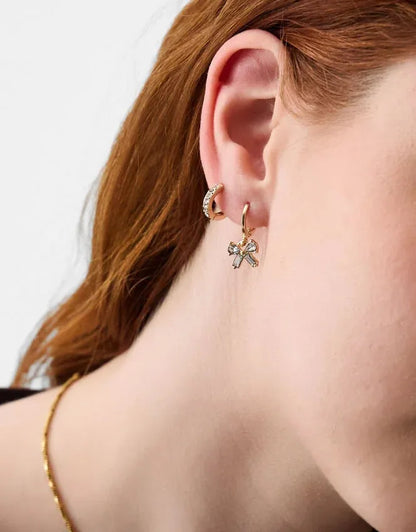 Gold-tone small hoop earrings with bow and crystal flower/star charms
