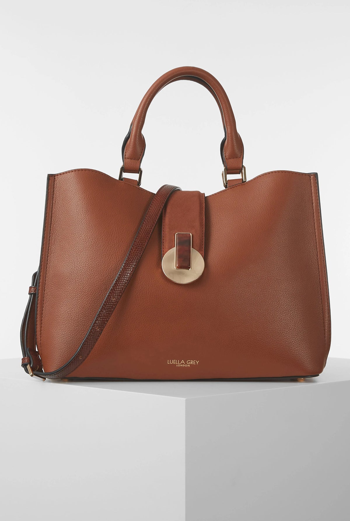 Brown leather tote bag with gold-tone clasp and top handles