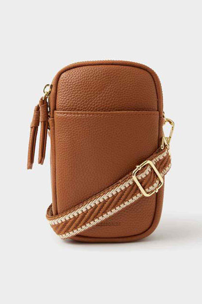 Accessorize tan mini crossbody bag with zip top, tassel pulls, and gold hardware