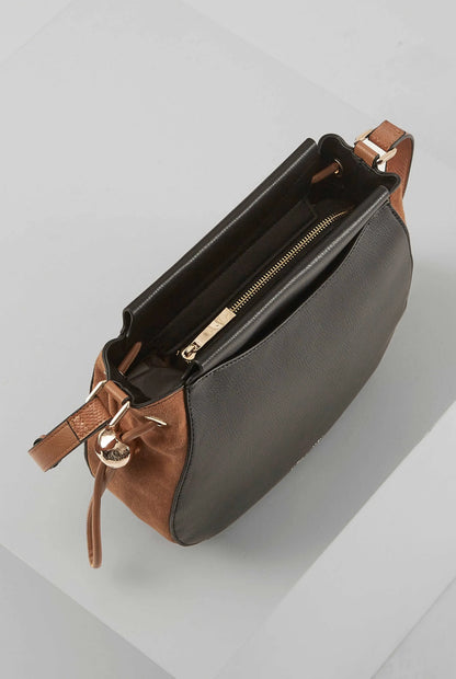 Black and tan leather crossbody bag with top zipper and side snap strap