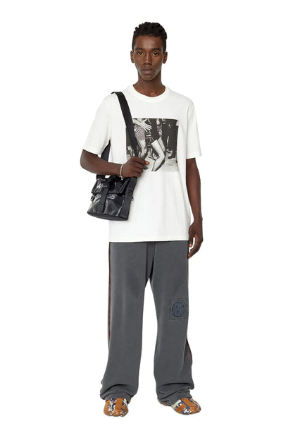 Black Diesel crossbody bag worn with adjustable strap and front logo