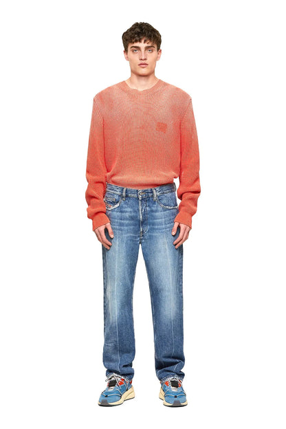 Blue wash denim jeans on model, straight legs and front button closure
