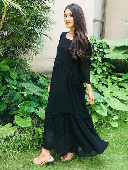 Black tiered midi dress with square neckline and 3/4 sleeves, angled profile