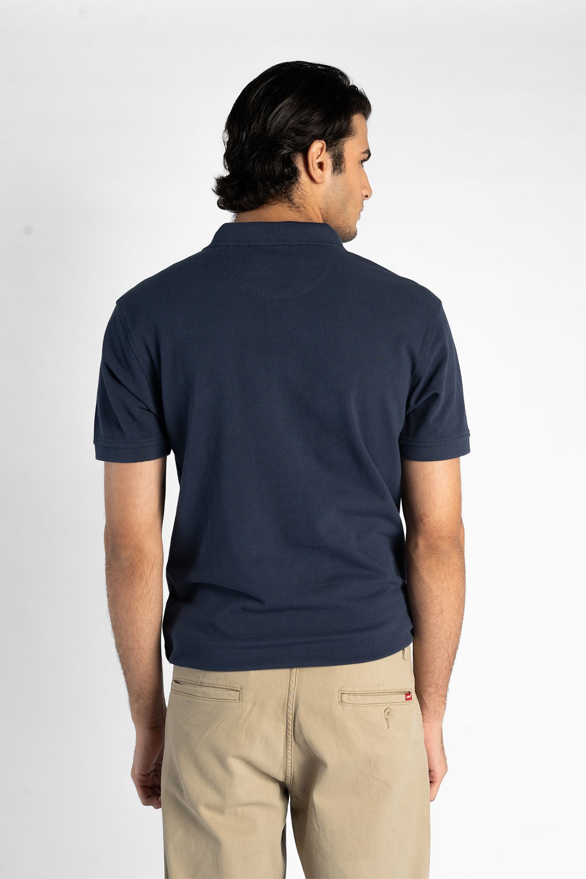 Men's navy polo shirt back view with short sleeves and placket