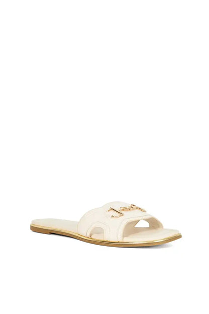 Ecru open-toe mule sandal with gold buckle ornament on strap