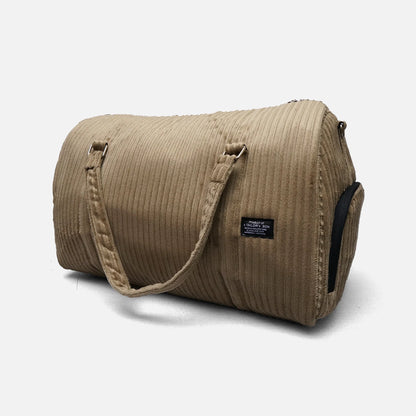 Khaki ribbed duffel bag with top handles, side zipper, and black-trim side pocket