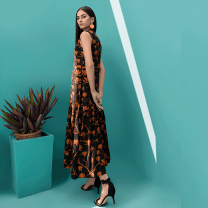 Sleeveless dark floral maxi dress, side view, orange leaf print and long skirt