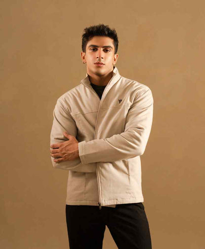 Beige zip-up jacket with stand collar and chest logo, fitted silhouette