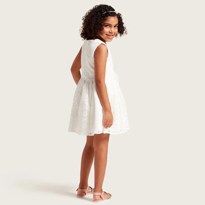 White sleeveless baby dress with rose print and flared skirt, side view