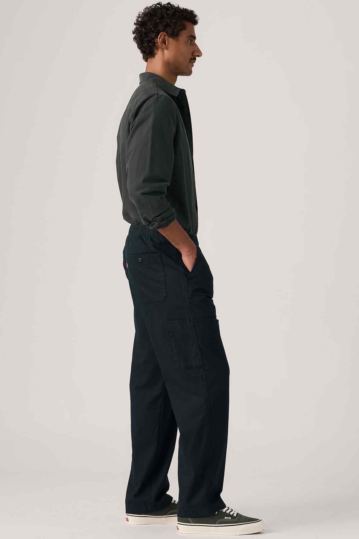 Men's Levi's dark work jacket and pants, side profile
